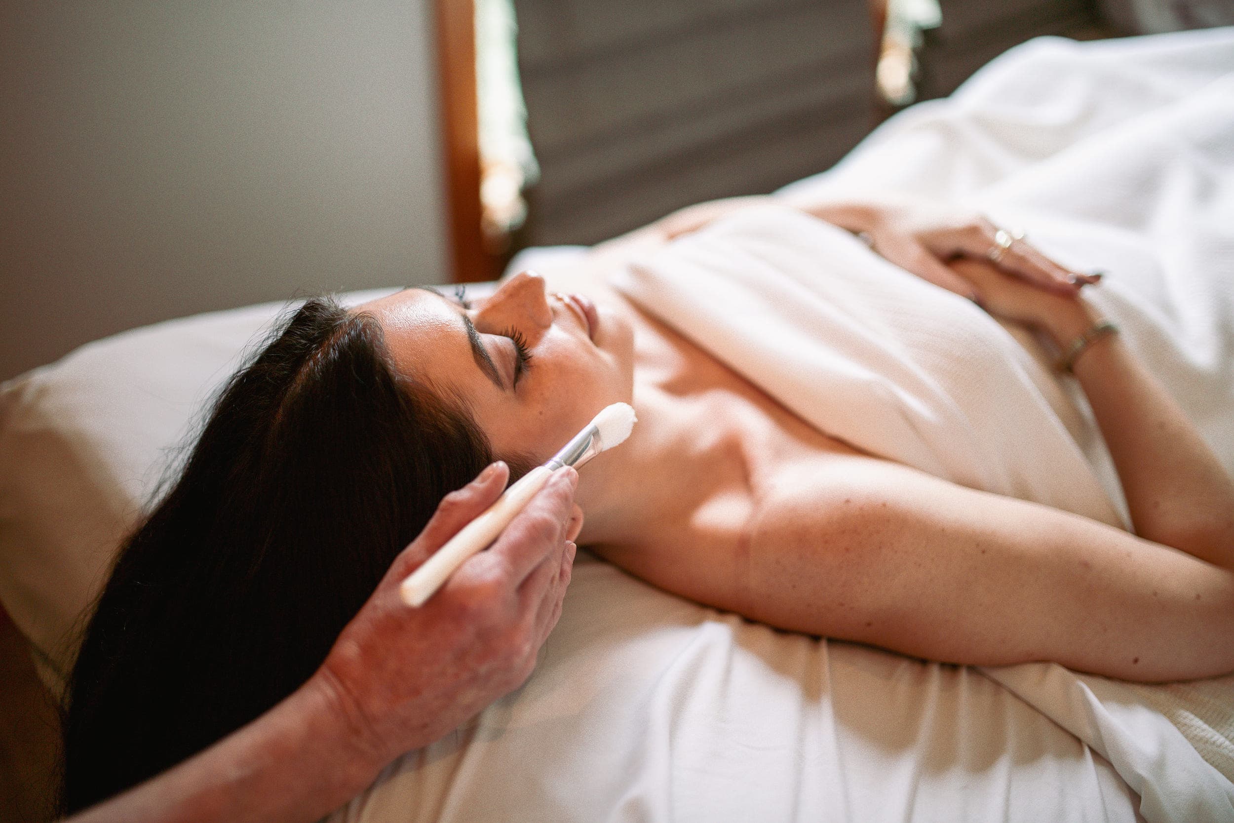 A woman laying in a bed at the spa pampering herself