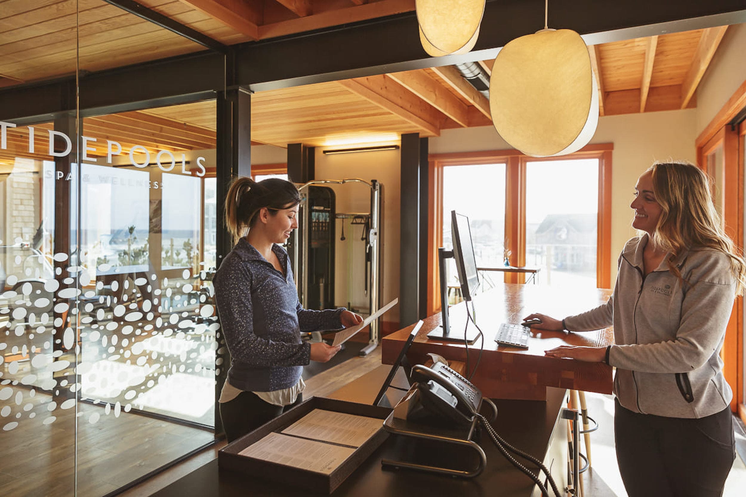 A person talking to the person at the front desk at Tides ppols