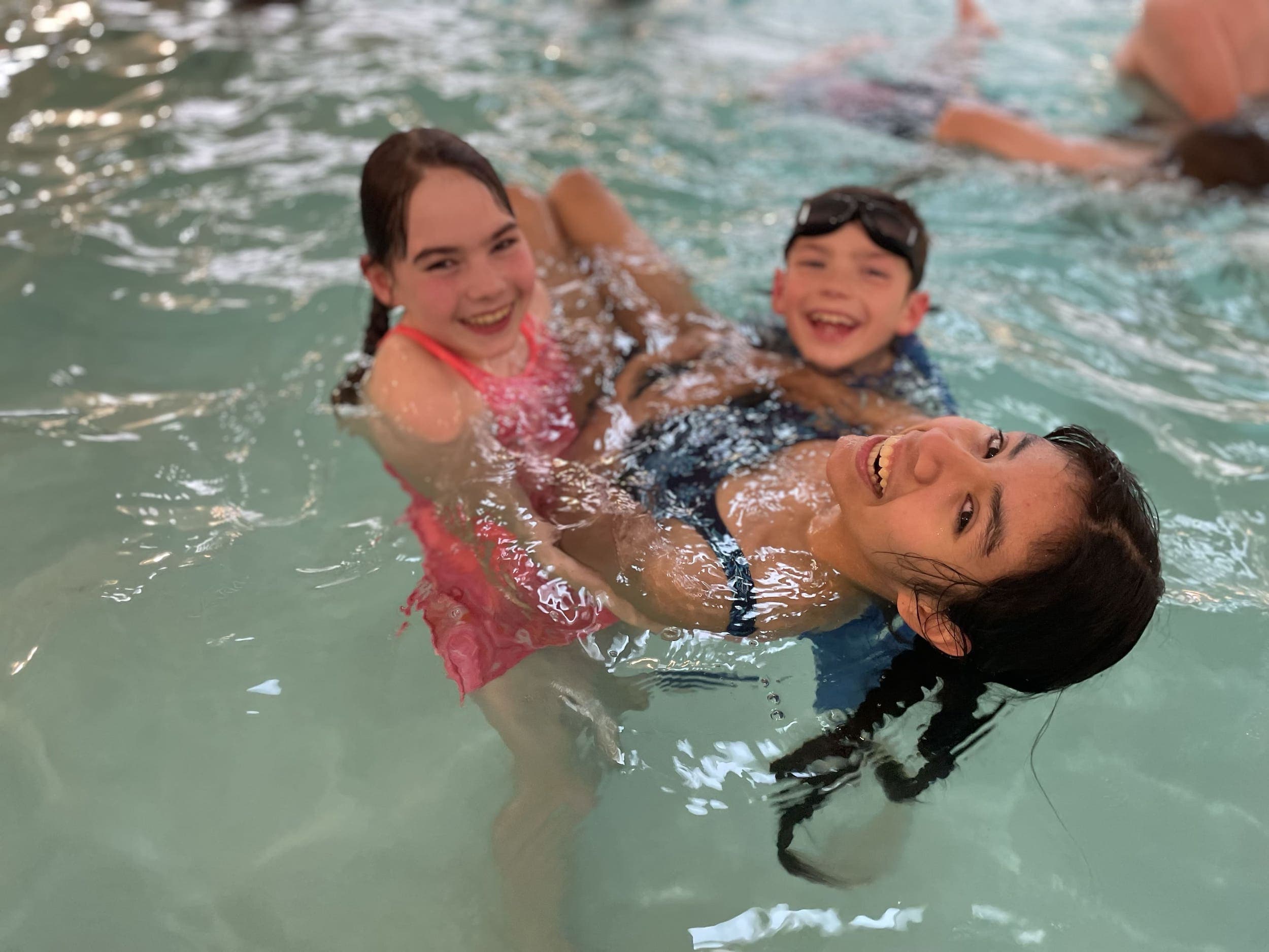 Three children playing in the pool at Inn at Cape Kiwanda