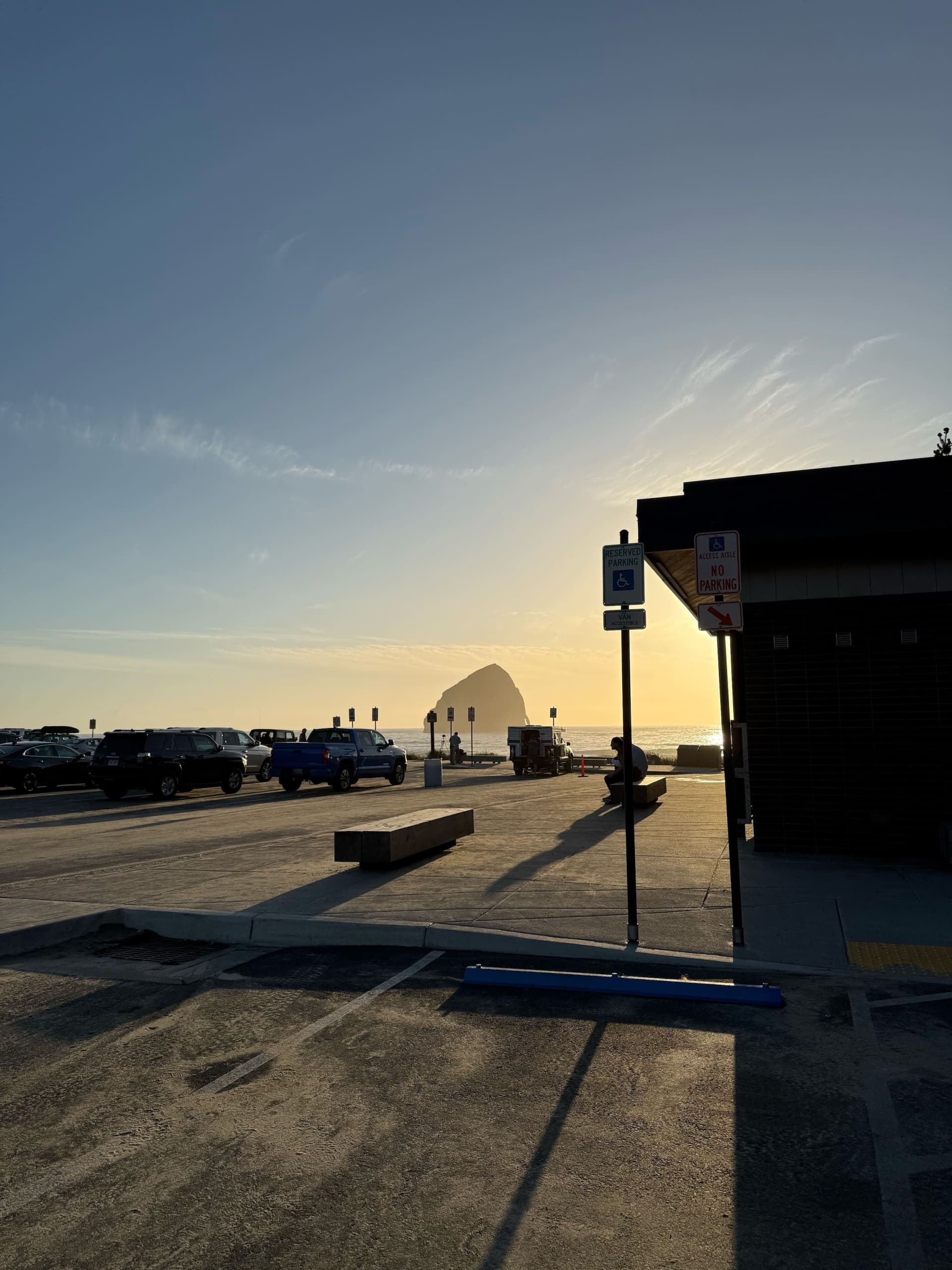 Cape Kiwanda Parking Lot Parking filled with cars and a few benches