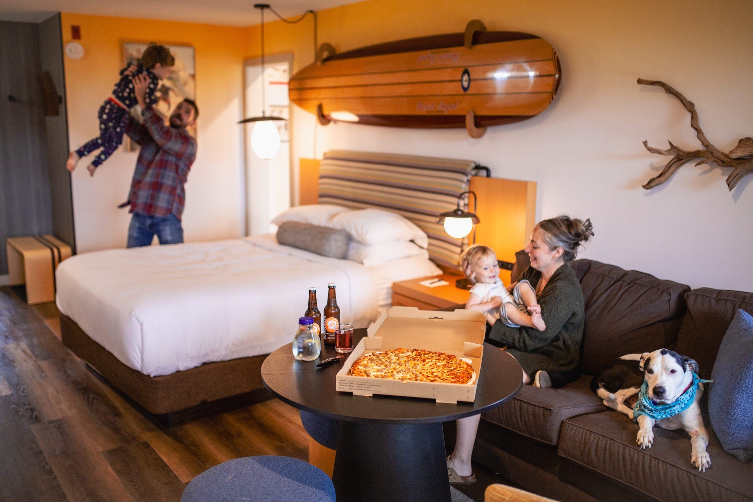 Family In The ONeill Surf Suite With Pizza at Inn at Cape Kiwanda