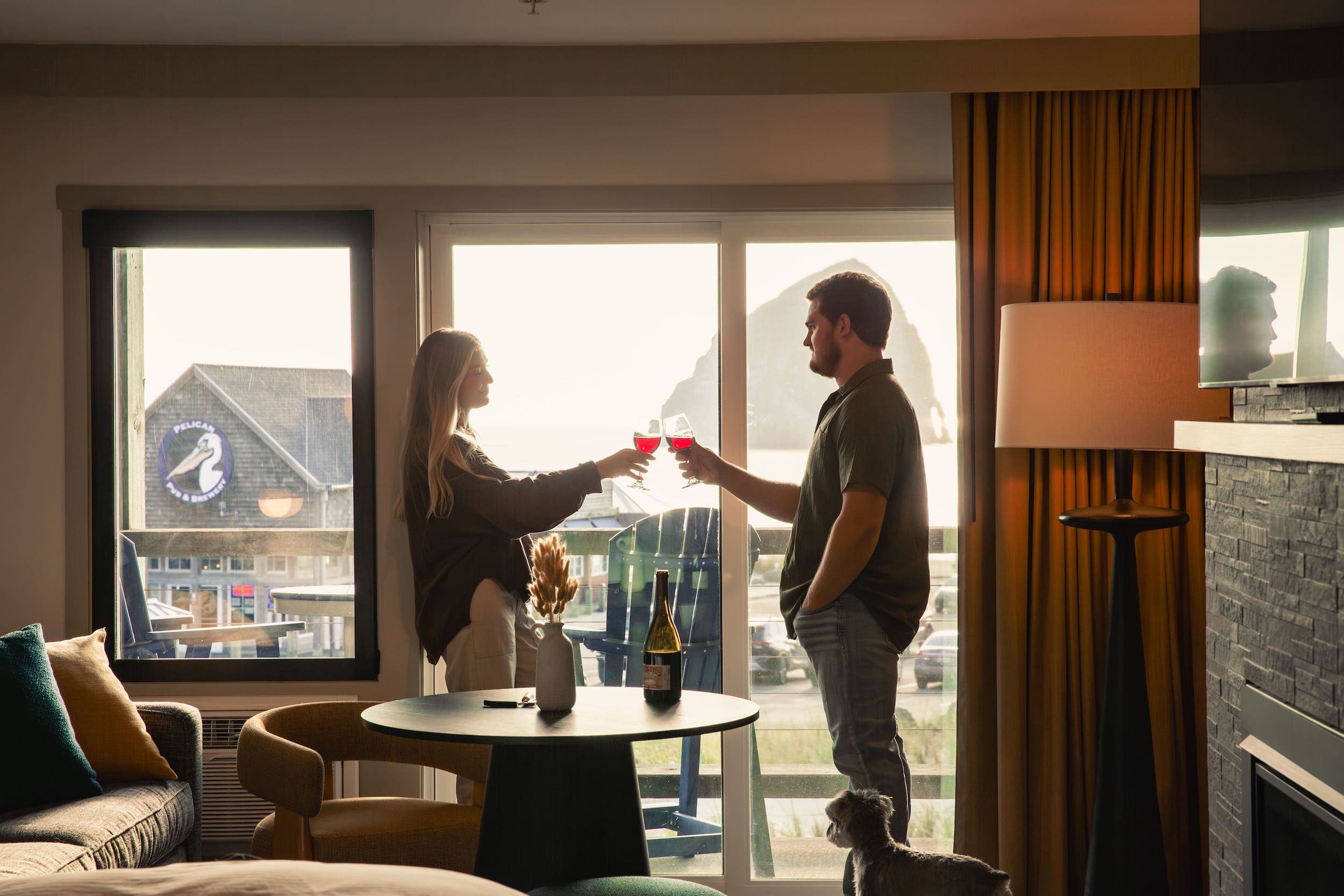 A couple in their room at Inn at Cape Kiwanda Having a glass of red wine