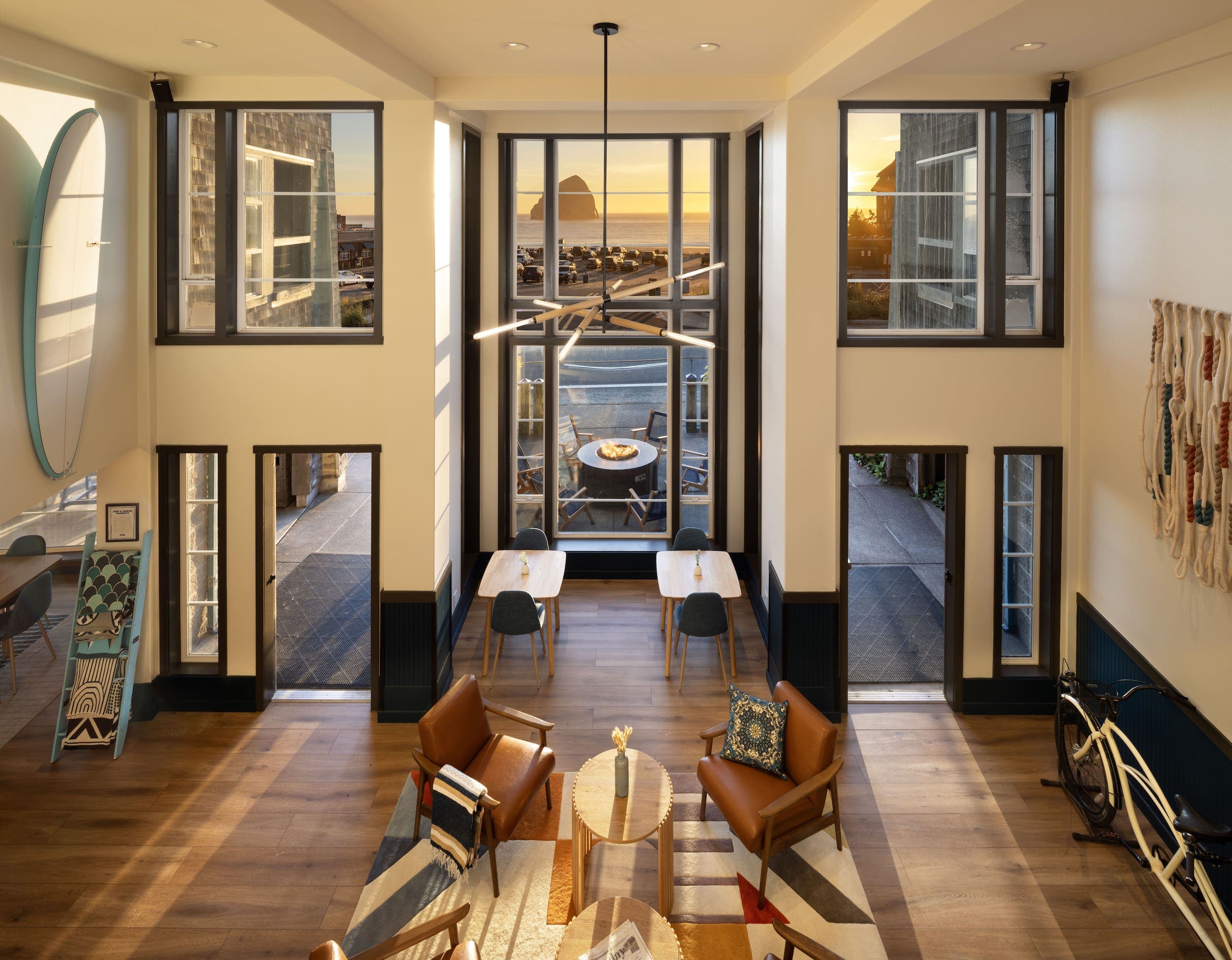The lobby of Inn at Cape Kiwanda with several seating spots in an airy open room with large ceilings and windows