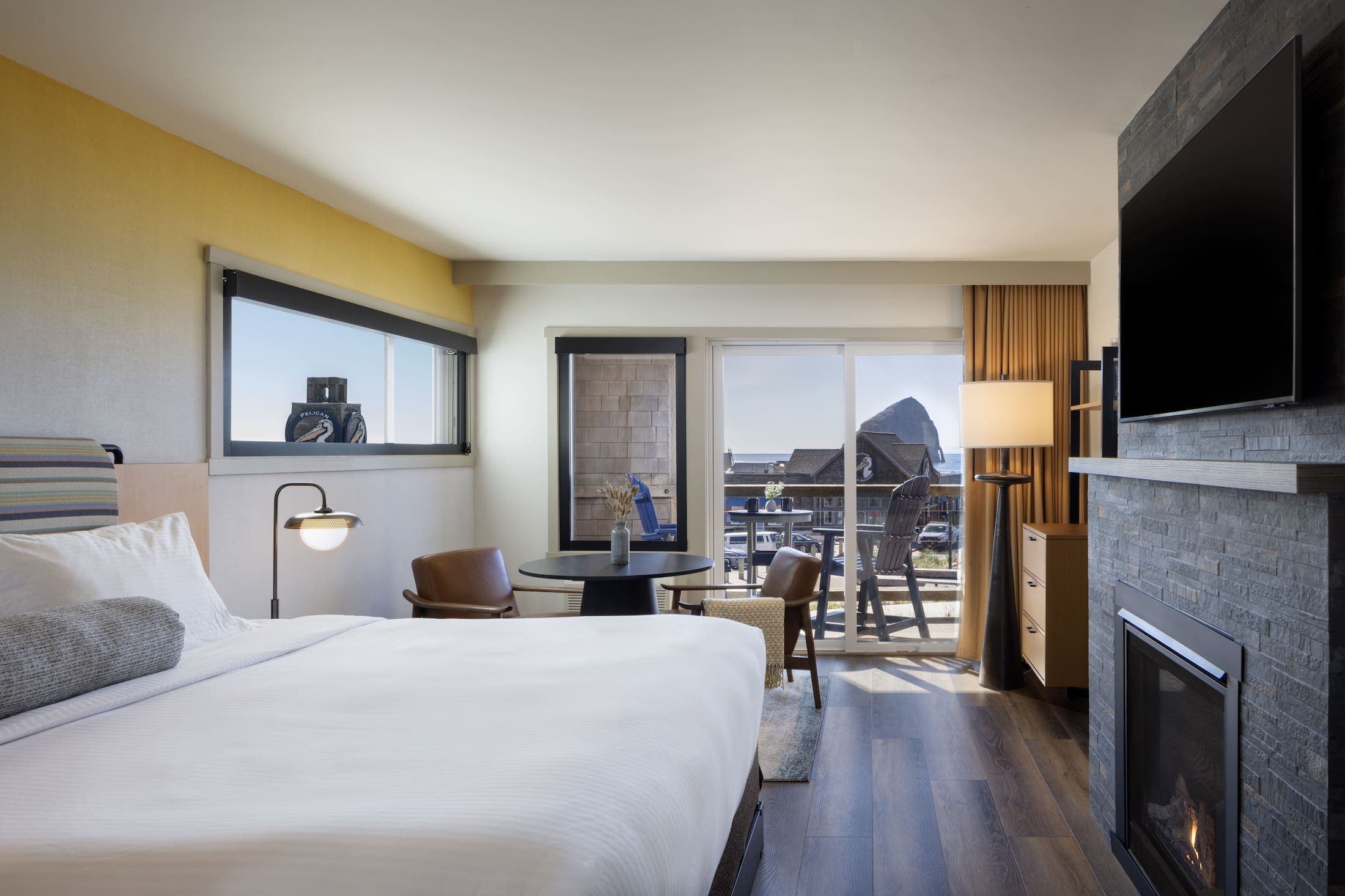 Inn At Cape Kiwanda Signature King Jetted Tub room with a fireplace, balcony and a round table for two