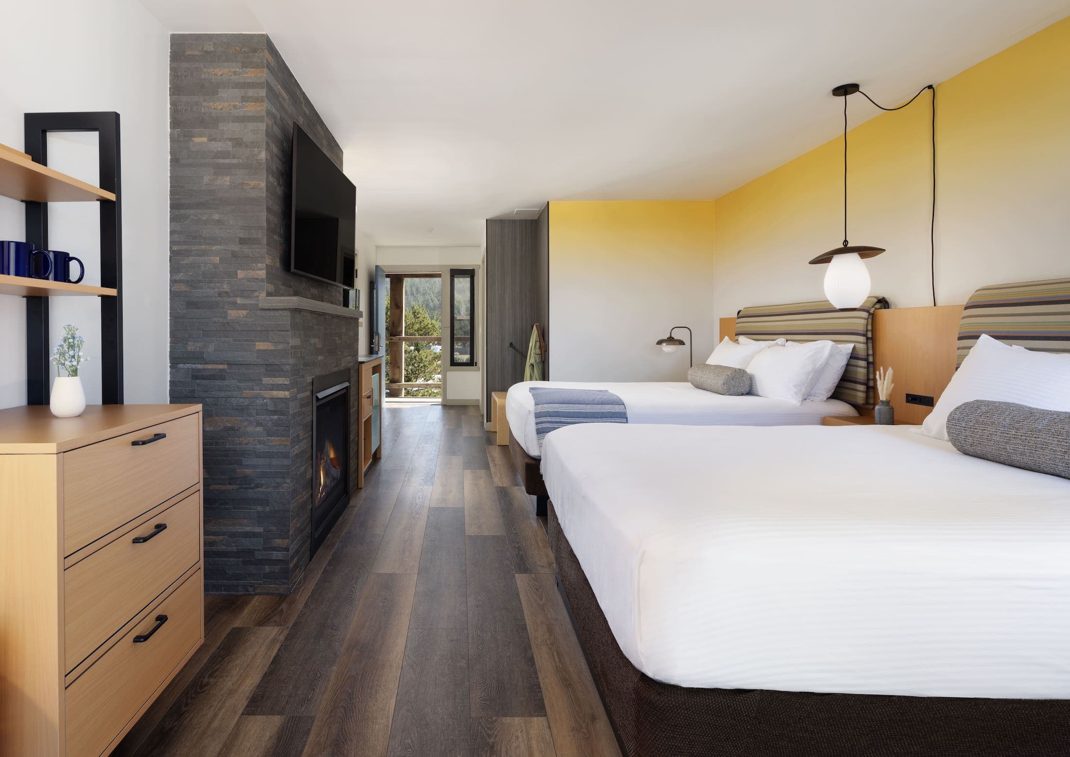 Inn At Cape Kiwanda Top Floor Two Queens Accessible room with a fireplace, dresser, and balcony