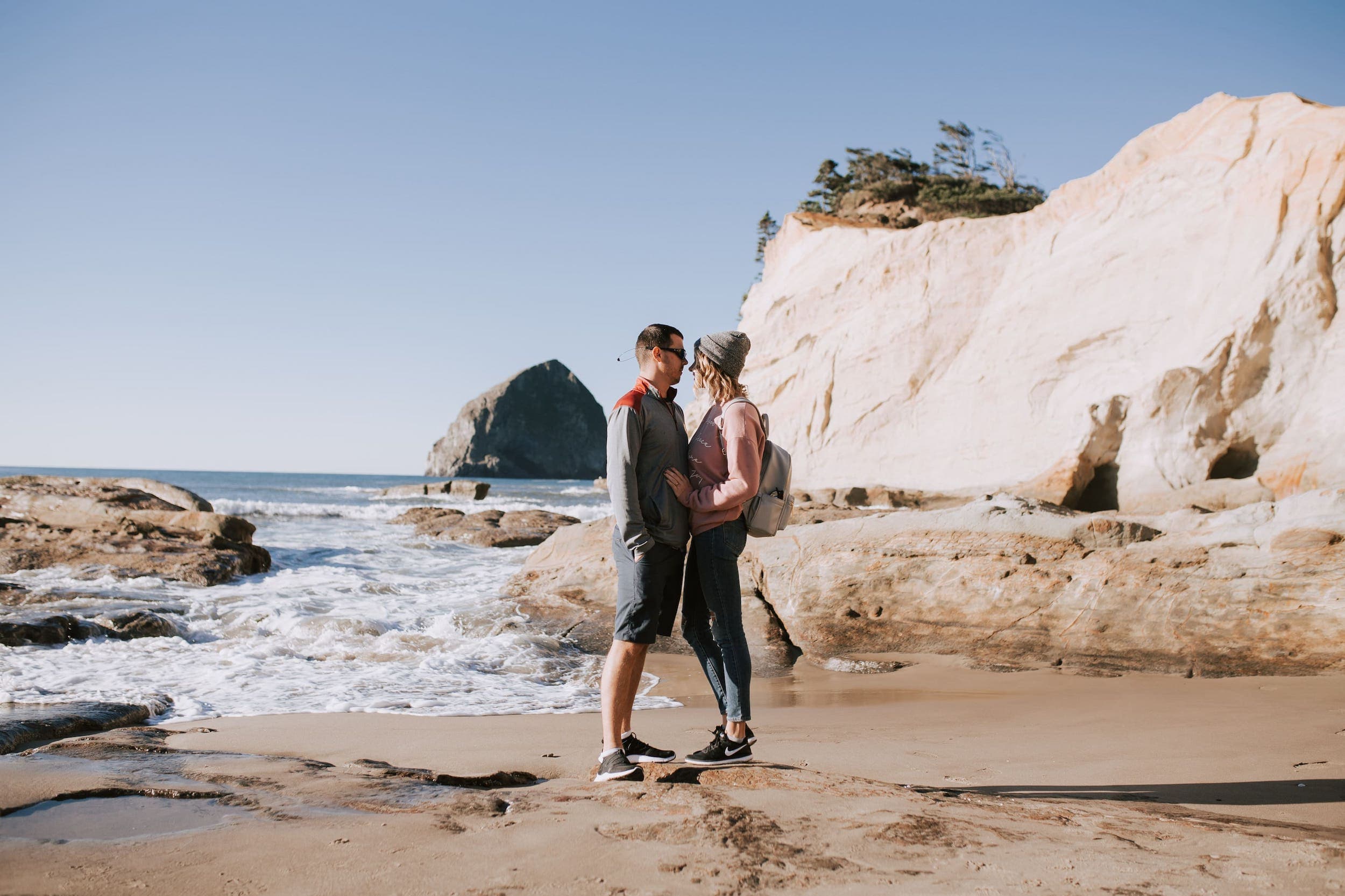 A couple embracing at The Cape near Inn at Cape Kiwanda